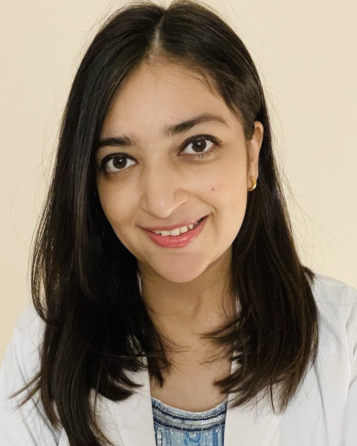 Dr. Shaliya Gupta, dermatologist, smiling in a white coat